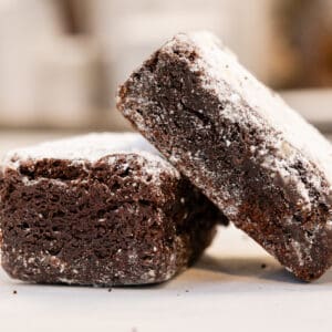 Two powdered chocolate brownies.