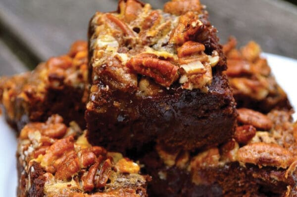 A close-up image of a stack of pecan pie brownies.