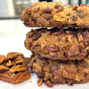 Three pecan cookies stacked high.