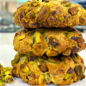 Three delicious pistachio cookies stacked high.