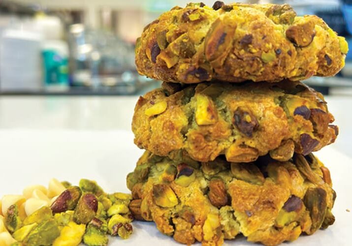 Three pistachio cookies with macadamia nuts.